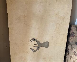 Large limestone slab with metal deer medallion