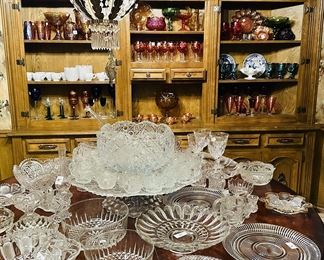 Large collection of cut glass platters and punch bowl set 