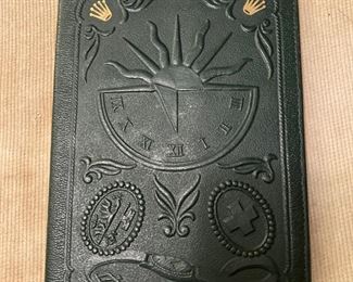  Rolex  1960 green leather passport holder-wallet.  Relief symbols in the front and back, which includes sun dial.  Inside fitted with two compartments lined with a green moire silk.   