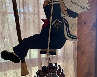 articulated wooden boy on swing