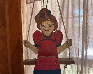 articulated wooden girl on swing