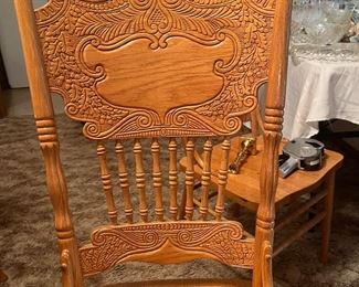 round, pedestal base oak table with pressed-back chairs