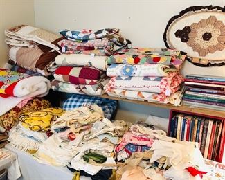 Quilts, quilt tops, 3 quilts handmade that have padding on back and are ready to quilt, vintage tablecloths, aprons, crochet, and lots of quilt books. 