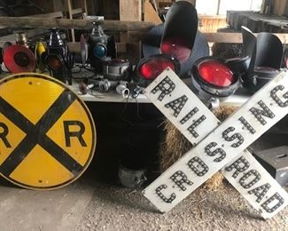 Classic RR sign and "cateye" crossbuck (very rare) and any flashers on table behind, all for sale