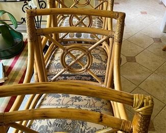 Four pristine McGuire chairs in coordinating fabrics