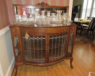 Outstanding tiger oak and leaded glass sideboard with mirror, lead crystal decanters, 