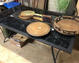 nice black patio table, lazy susans and vintage tennis raquets, 