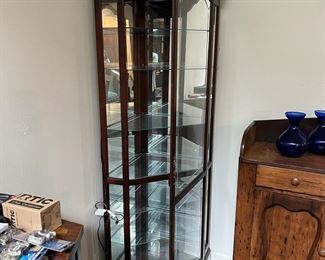 Glass curio cabinet by Howard Miller