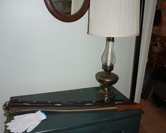 small chest of drawewrs, belts, lamp, mirror