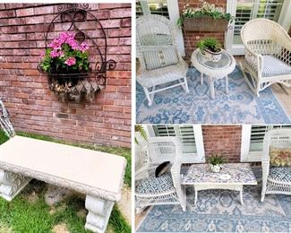 Patio Furniture and Decor: Iron planters, White wicker rocking chairs and side tables, outdoor rugs, cement bench, live plants