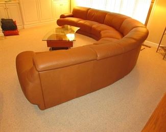 Item 1: Five-piece modern brown (cognac color) curved leather sectional sofa with adjustable back. Brand name not found. Both end pieces each measure 65” wide x 42” deep x 30” tall (with closed back). Three center sections each measure 40” wide x 42” deep x 30” tall (with closed back). PRICE: $1,995.00