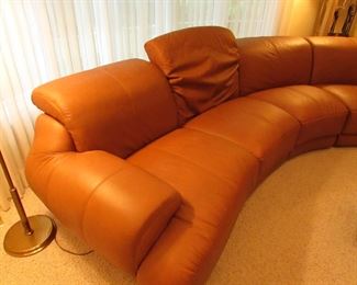 Item 1: Five-piece modern brown (cognac color) curved leather sectional sofa with adjustable back. Brand name not found. Both end pieces each measure 65” wide x 42” deep x 30” tall (with closed back). Three center sections each measure 40” wide x 42” deep x 30” tall (with closed back). PRICE: $1,995.00