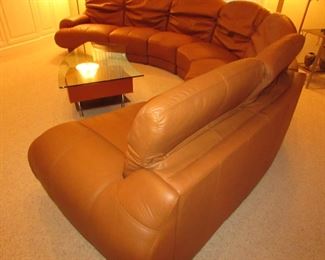 Item 1: Five-piece modern brown (cognac color) curved leather sectional sofa with adjustable back. Brand name not found. Both end pieces each measure 65” wide x 42” deep x 30” tall (with closed back). Three center sections each measure 40” wide x 42” deep x 30” tall (with closed back). PRICE: $1,995.00