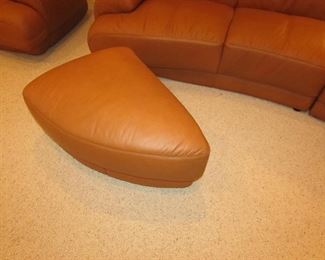 Item 2: Two-piece modern brown (cognac color) curved leather sectional sofa with adjustable backs and with (2) rolling ottomans. Brand name not found. Each section measures 65” wide x 42” deep x 30” tall. Each ottoman measures 40” wide x 25” deep x 18” tall. PRICE: $1,895.00