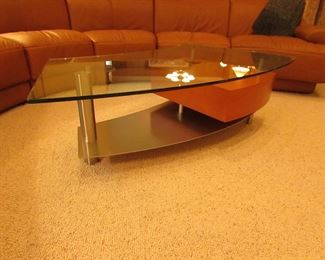 Item 3: Contemporary stainless, wooden, and glass top cocktail table with drawer. Brand name not found. 57.5” wide x 29” wide x 16.5” tall. PRICE: $650.00