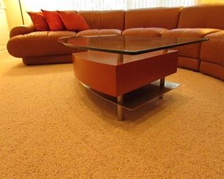 Item 3: Contemporary stainless, wooden, and glass top cocktail table with drawer. Brand name not found. 57.5” wide x 29” wide x 16.5” tall. PRICE: $650.00