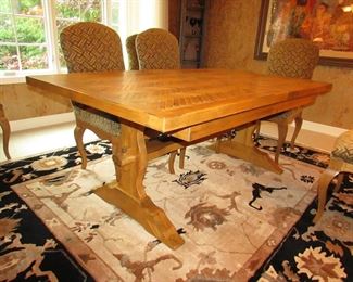 Item 4: Cellura Designs French Country-style pine trestle dining table with herringbone parquetry top, one 2’ leaf, and (8) side chairs. Table without the 2’ leaf measures 6’2” long x 42” wide x 29” tall. Each chair measures 21” wide x 23.5” deep x 42” tall. PRICE: $2,995