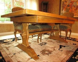 Item 4: Cellura Designs French Country-style pine trestle dining table with herringbone parquetry top, one 2’ leaf, and (8) side chairs. Table without the 2’ leaf measures 6’2” long x 42” wide x 29” tall. Each chair measures 21” wide x 23.5” deep x 42” tall. PRICE: $2,995