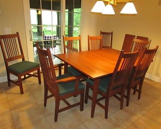Item 15: L. & Sons Woodshop of Apple Creek, Ohio cherry Mission-style dining table with (8) chairs. (six side chairs and two arm chairs). Also with (2) leaves that are each 1’ wide. Table without leaves is 5’ long x 42” wide x 30” tall. PRICE: $1,200.00