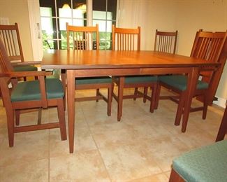 Item 15: L. & Sons Woodshop of Apple Creek, Ohio cherry Mission-style dining table with (8) chairs. (six side chairs and two arm chairs). Also with (2) leaves that are each 1’ wide. Table without leaves is 5’ long x 42” wide x 30” tall. PRICE: $1,200.00