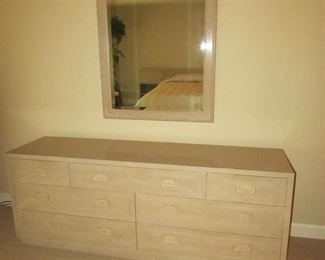 Item 24: Henredon blonde oak campaign style 7-drawer dresser with mirror. Dresser measures 6’ long x 18” deep x 28” tall. Mirror measures 49” long x 34” wide. PRICE: $550.00