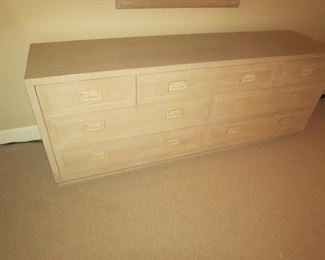 Item 24: Henredon blonde oak campaign style 7-drawer dresser with mirror. Dresser measures 6’ long x 18” deep x 28” tall. Mirror measures 49” long x 34” wide. PRICE: $550.00