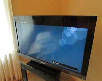 Item 27: Sony Bravia 40” television, model KDL-40EX500, manufactured in 2010. Comes with remote and powers on. Media stand is also included. Media stand measures 30” wide x 22.5” deep x 22” tall. PRICE: $50.00