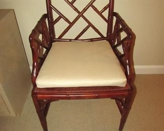 Item 29: Wooden bamboo-style arm chair with caned seat and removable custom cushion. No makers mark. 23” wide x 36” tall x 19.5” deep. PRICE: $150.00