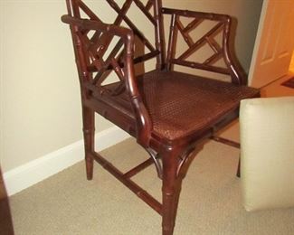 Item 30: Another Wooden bamboo-style arm chair with caned seat and removable custom cushion. No makers mark. 23” wide x 36” tall x 19.5” deep. PRICE: $150.00