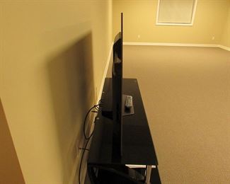 Item 47: Sony Bravia 55” XBR-55A8F OLED smart TV with contemporary Bell O’ metal and glass media stand. Media stand measures 52” wide x 22.25” tall x 17.5” deep. PRICE: $650.00