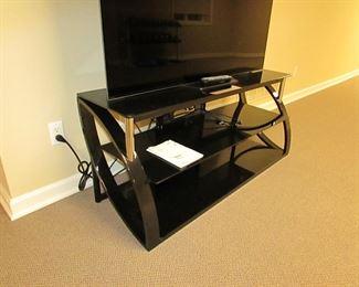 Item 47: Sony Bravia 55” XBR-55A8F OLED smart TV with contemporary Bell O’ metal and glass media stand. Media stand measures 52” wide x 22.25” tall x 17.5” deep. PRICE: $650.00