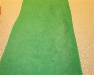 Item 48: “Big Moss Golf” 2-hole indoor putting green (mat). 12’ long at longest point x 4’ wide at widest point. Rolls for easy transport. PRICE: $125.00