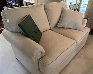 One of a pair of upholstered love seats