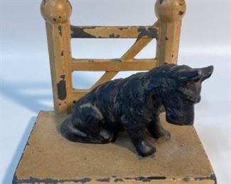 Antique HUBLEY CAST IRON SCOTTIE DOG BY FENCE BOOKEND or doorstop
