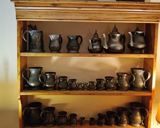 antique pewter tankards, baskets, and shelving unit