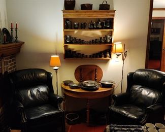 antique pewter tankards and bowls, leather chairs, antique floor lamps, 19th century distressed pine furniture