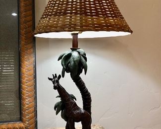 Giraffe with palm tree base and woven wicker shade