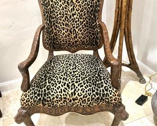 Dramatic leopard print chair with leopard heads and feet on legs