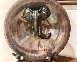 Striking elephant head charger on metal stand