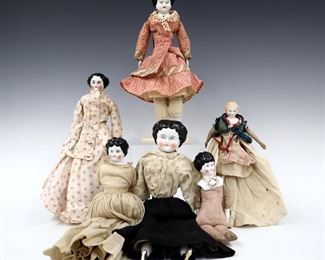 Six 19th to early 20th century dolls. China heads with molded hair and painted detail, on cloth jointed bodies, some with porcelain lower arms and legs. Includes five with Brown painted hair and one Blonde, in various dresses. Some wear to paint, fabric with some fading, staining and small holes, two lack one or both arms. Up to 13" long. ESTIMATE $100-200