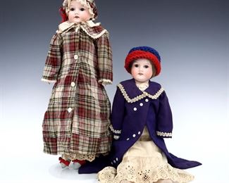 Two early 20th century Armand Marseille Model 370 dolls. Full Bisque heads with Light Brown hair, sleep eyes, open mouths with teeth and painted detail, on kid jointed bodies with porcelain lower arms. Includes one wearing a muslin dress with Purple coat, and one wearing a White polka dot dress with plaid coat and matching bonnet. Impressed "370 / A.M. 9 DET / Made in Germany" at necks. Minor wear to paint, fabric with some fading, staining and holes, losses to wigs. Each 21" long. ESTIMATE $100-150