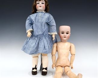 Two early 20th century Armand Marseille "Queen Louise" dolls. Bisque socket heads with sleep eyes, open mouths with teeth and painted detail on jointed composite bodies. Includes one wearing a Blue floral dress with lace and leather shoes, and one without clothing or wig. Impressed "Queen Louise / Germany" at necks. Slight wear to paint, dressed Louise with touched-up eyes and chipped tooth, fabric with some fading. Each 23" long. ESTIMATE $100-200