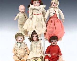 Six 19th and early 20th century dolls, mostly German. Bisque heads with painted detail on various bodies, two with sleep eyes and two with stationary eyes, by makers including Walther & Sohn and Heinrich Handwerck. Some with impressed maker's marks and numbers. Some wear and minor damage, fabric with fading and some stains. Up to 12" long. ESTIMATE $100-150