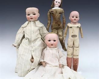 Four 19th and early 20th century dolls. Bisque heads with painted detail on various bodies, three with sleep eyes and one with stationary eyes by makers including Fulper and Armand Marseille. Some with impressed maker's marks and numbers. Some wear and minor damage, fabric with fading and some stains. Up to 13 1/2" long. ESTIMATE $100-150