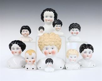 Eleven turn of the century China and Bisque porcelain doll heads. Various sizes and hair styles with painted detail. Several marked "Germany". Some wear to paint, one with hairline to face. 1 3/4" to 6" high. ESTIMATE $100-200