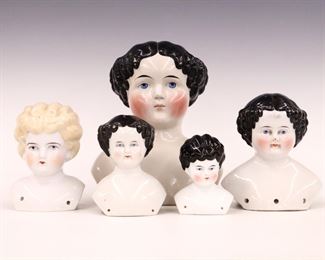 Five turn of the century China doll heads. Various sizes and hair styles with painted detail. One marked "Germany". Some wear to paint, one with small hairline to face, small chips to bases. 3 3/4" to 8 1/2" high. ESTIMATE $100-200