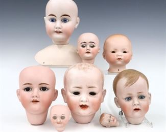 Eight turn of the century German Bisque porcelain doll heads. Various sizes and hair styles with painted detail by makers including Armand Marseille, Gebruder Kuhnlenz, Henrich Handwerck. Each with impressed marks or numerals. Some wear to paint and minor damage, several lack sleep eyes. 2" to 8 1/2" high. ESTIMATE $100-200