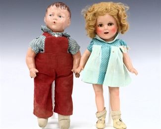 Two early 20th century American composite dolls, c. 1930s. Includes an Ideal Toy Co. "Shirley Temple" with composite head, mohair wig and sleep eyes on a jointed composite body wearing the original Blue dress with printed label, and an Madame Hendren "whistling" boy with composite head and painted eyes and hair on a jointed cloth body with composite arms wearing Red overalls. Some wear and minor damage, craquelure and flaking to composite on boy, fabric with some wear and staining. Up to 14" high. ESTIMATE $100-150