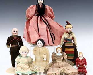Seven 19th and early 20th century dolls. Bisque and China heads with painted detail on various bodies. Some with impressed numbers. Some wear and minor damage, Frozen Charlotte with repaired arm, fabric with fading and some stains. Up to 11" long. ESTIMATE $100-150