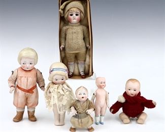 Six antique and vintage Bisque dolls by various makers. Bisque head dolls with painted detail on Bisque and composite bodies. One "My Darling Biscuit Babies" in original box. Some wear and minor damage overall. Up to 7" long. ESTIMATE $100-150